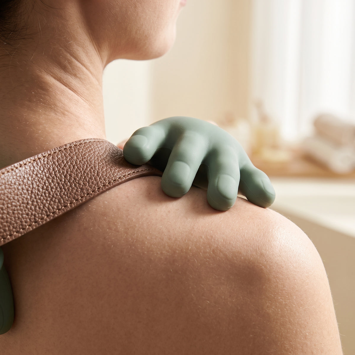 Close-up of the soft silicone finger heads resting on a shoulder