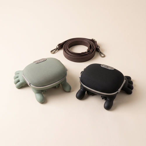 Mellohand cordless neck and shoulder massager in sage green and black with its leather-look strap